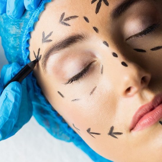 Peaceful young patient with dotted lines on the face in an examination room